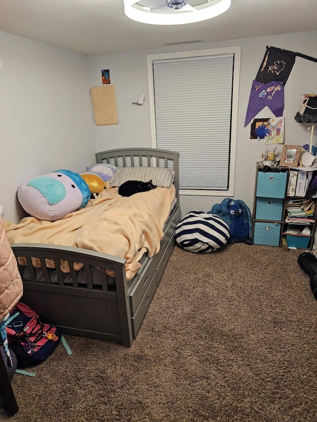 bedroom featuring dark colored carpet