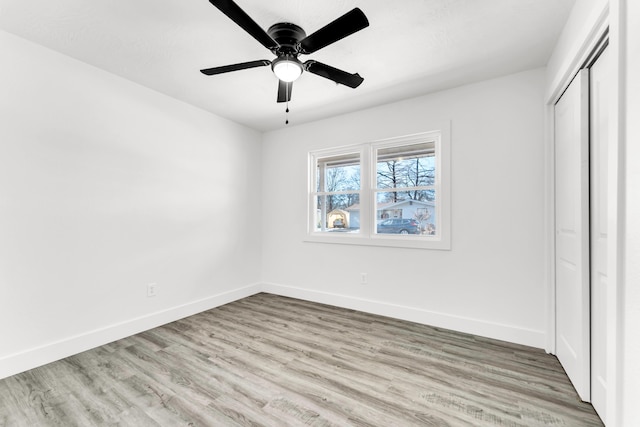 unfurnished bedroom with ceiling fan, a closet, and light hardwood / wood-style flooring