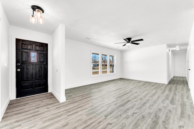 foyer entrance with ceiling fan and light hardwood / wood-style flooring