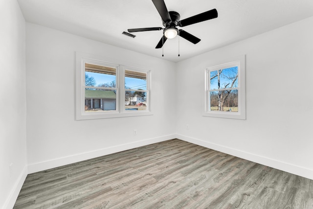 empty room featuring ceiling fan and light hardwood / wood-style floors