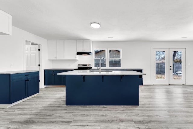 kitchen with white cabinetry, blue cabinetry, electric range, and sink