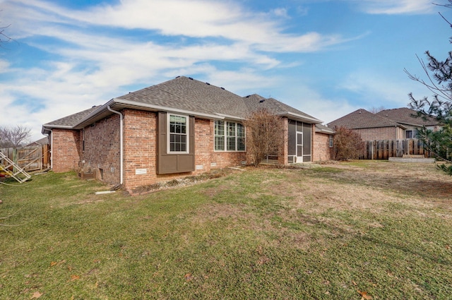 rear view of property with a yard