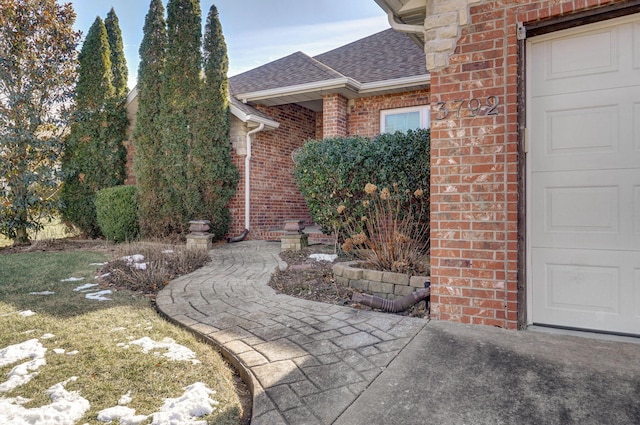 doorway to property with a garage