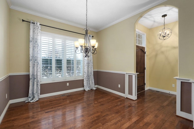 unfurnished dining area with dark hardwood / wood-style flooring, a chandelier, and ornamental molding