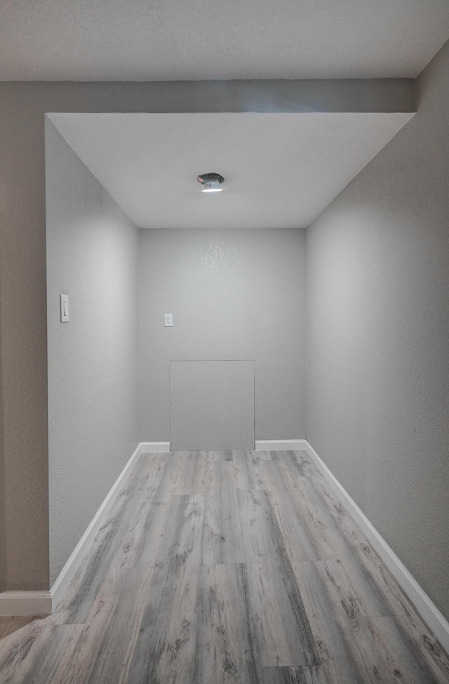 empty room with light hardwood / wood-style flooring