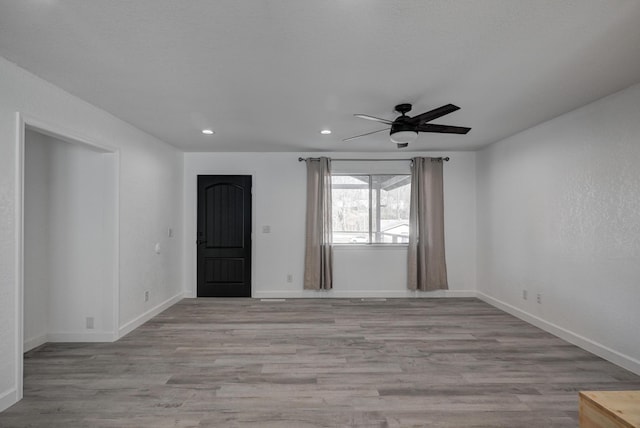 unfurnished room featuring light wood-type flooring and ceiling fan