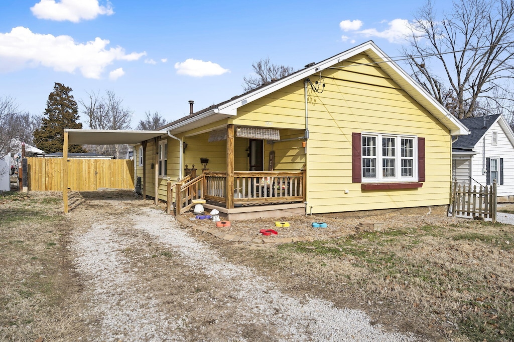 view of front of property with a porch and a carport