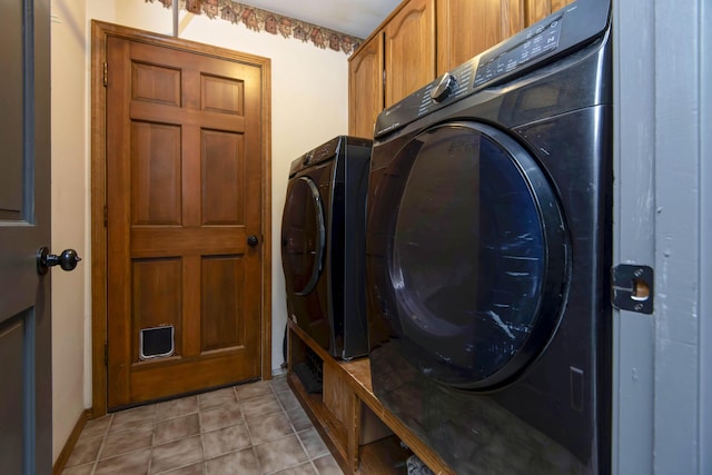 clothes washing area with independent washer and dryer and cabinets