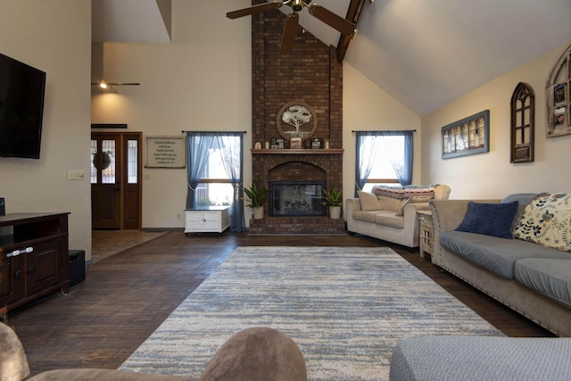 living room featuring high vaulted ceiling, a wealth of natural light, dark hardwood / wood-style flooring, and a fireplace