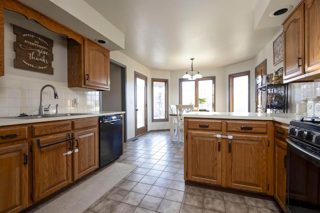 kitchen featuring pendant lighting, sink, light tile patterned floors, black appliances, and decorative backsplash