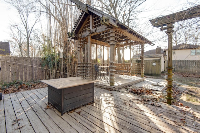 wooden terrace featuring a shed