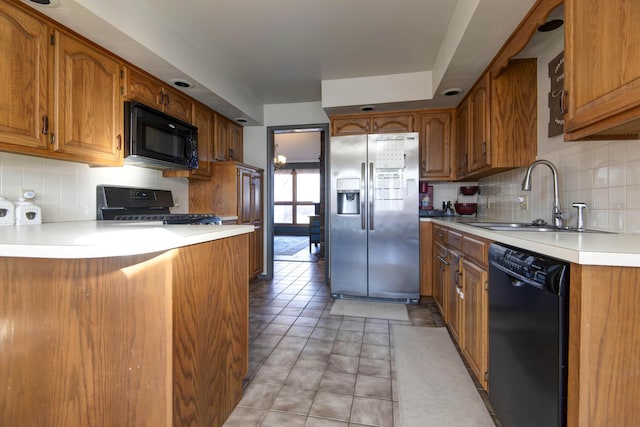 kitchen with black appliances, light tile patterned floors, tasteful backsplash, and sink