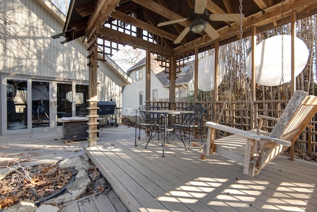 wooden deck featuring ceiling fan