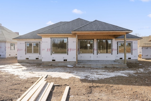 unfinished property featuring roof with shingles and crawl space