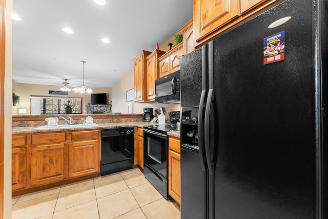 kitchen featuring black appliances, kitchen peninsula, sink, light stone countertops, and light tile patterned floors