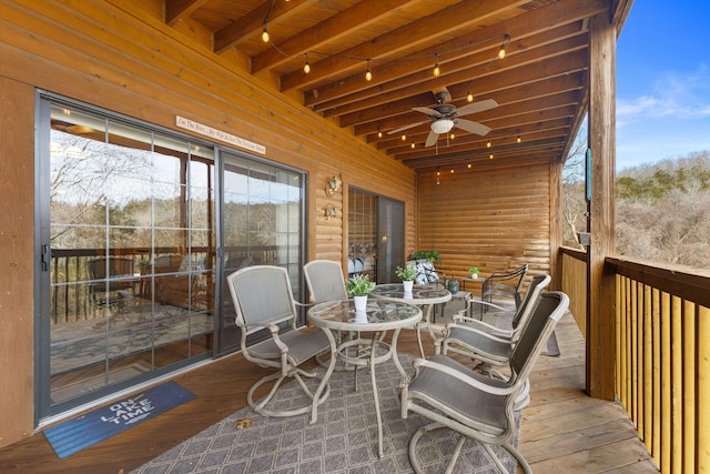 sunroom featuring ceiling fan, wood ceiling, and beam ceiling