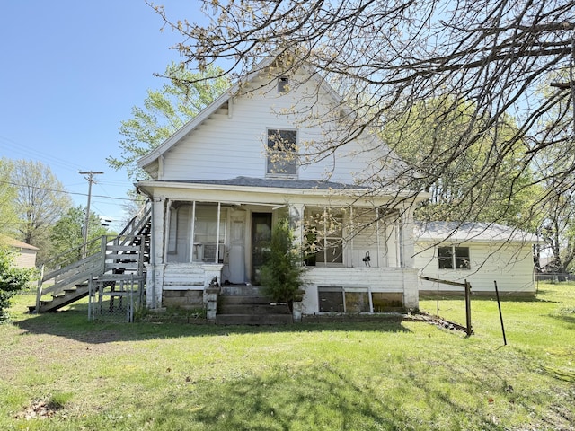 view of front facade featuring a front yard and stairs