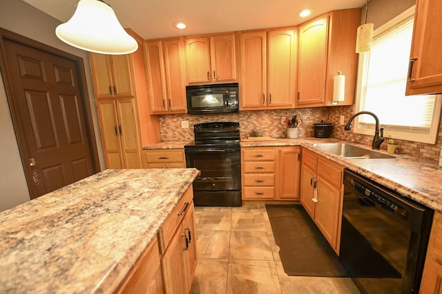 kitchen with decorative backsplash, sink, pendant lighting, and black appliances