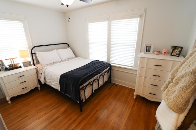 bedroom with ceiling fan and dark wood-type flooring