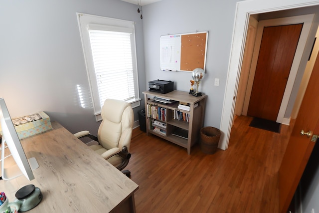 home office with dark wood-type flooring