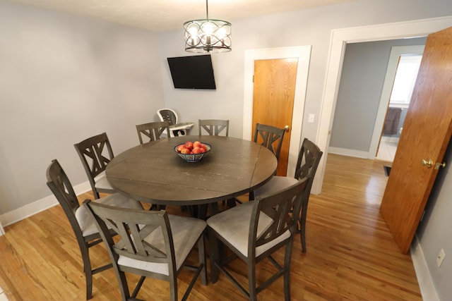 dining room with a chandelier and light hardwood / wood-style flooring