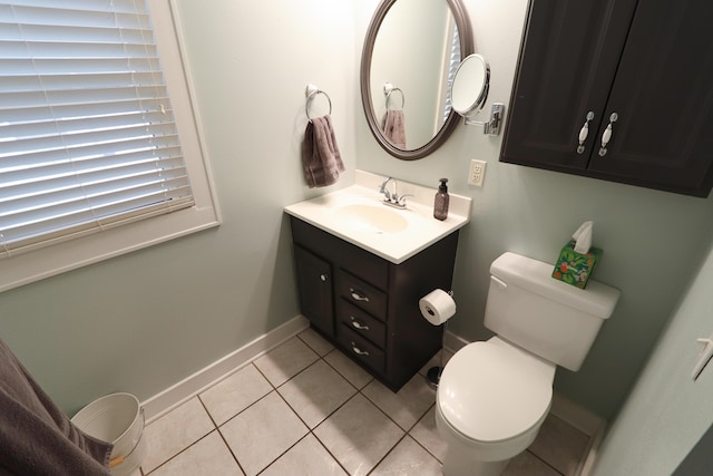 bathroom featuring toilet, vanity, and tile patterned floors