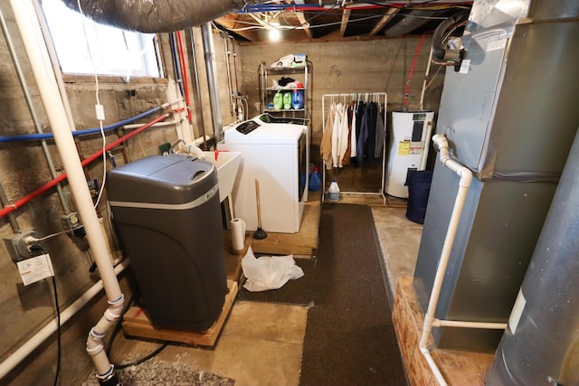 utility room with separate washer and dryer and electric water heater