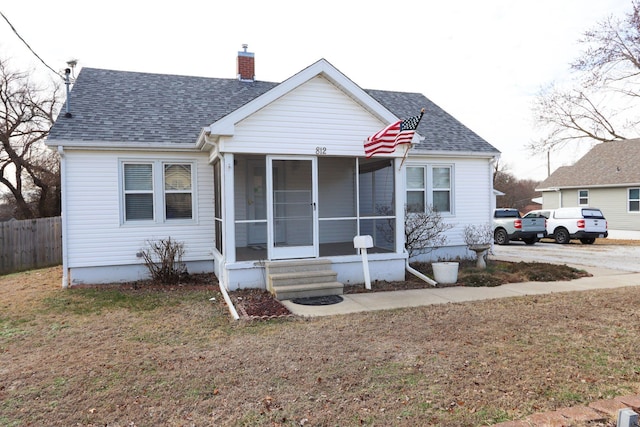 bungalow-style home featuring a front lawn