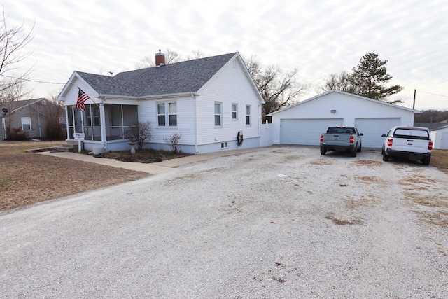 view of front of home featuring a garage and an outdoor structure