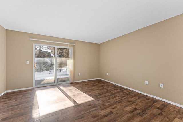 empty room with dark hardwood / wood-style flooring