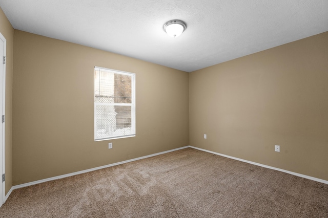 unfurnished room with carpet floors and a textured ceiling