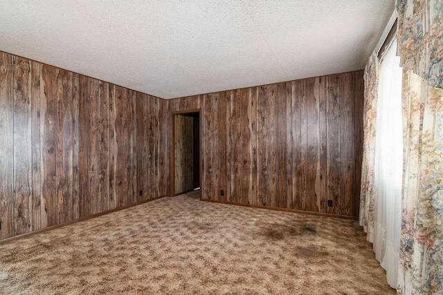 carpeted spare room with a textured ceiling