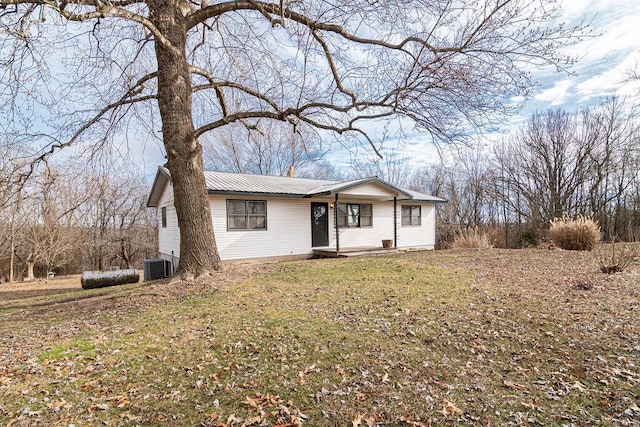 ranch-style house with a front lawn and central AC