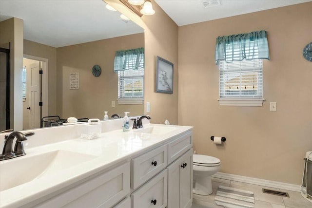 bathroom featuring toilet, vanity, and tile patterned flooring