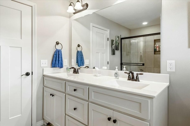 bathroom featuring an enclosed shower and vanity