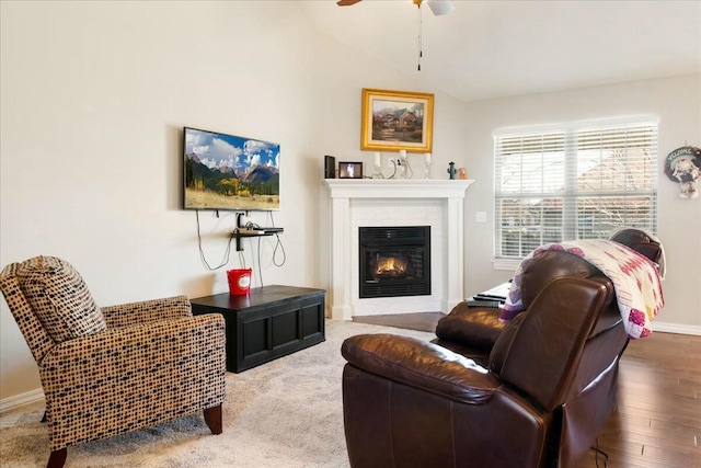 living room with ceiling fan, hardwood / wood-style floors, and vaulted ceiling