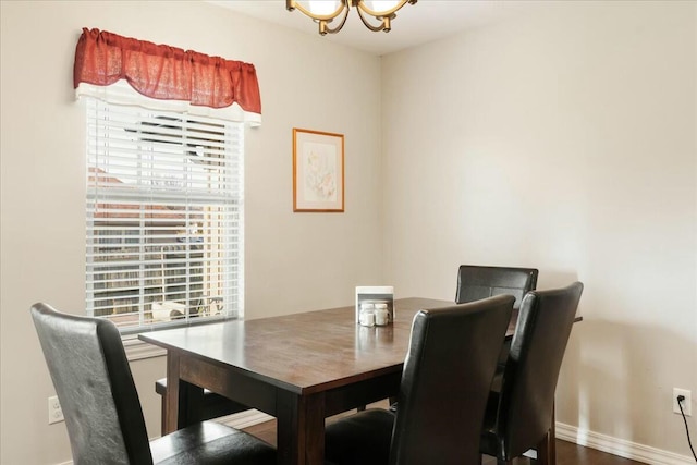 dining area with an inviting chandelier