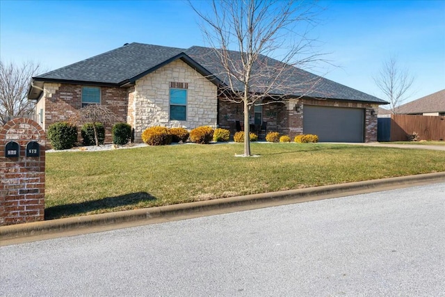 ranch-style home with a front lawn and a garage