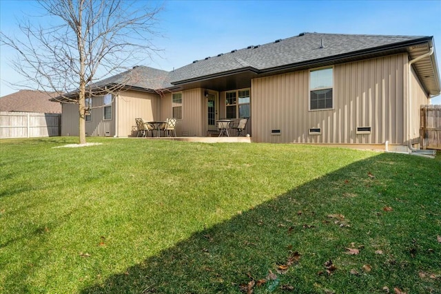 rear view of property with a patio area and a yard