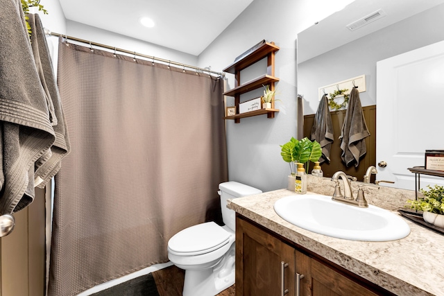 bathroom with hardwood / wood-style flooring, toilet, and vanity