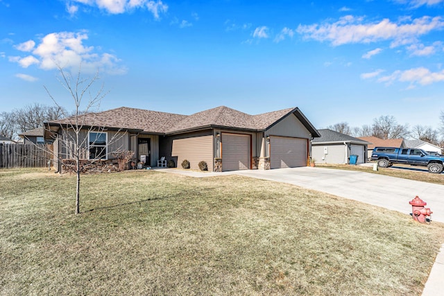 ranch-style house featuring a front yard and a garage