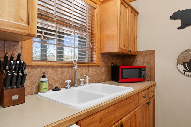 kitchen featuring sink and tasteful backsplash