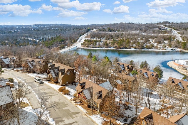 snowy aerial view with a water view