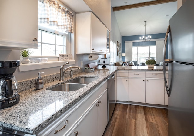 kitchen with white cabinetry, sink, vaulted ceiling with beams, dark hardwood / wood-style flooring, and stainless steel appliances