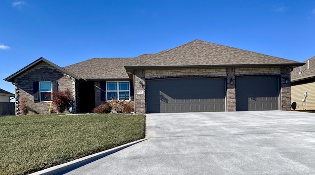 view of front of house with a garage and a front lawn