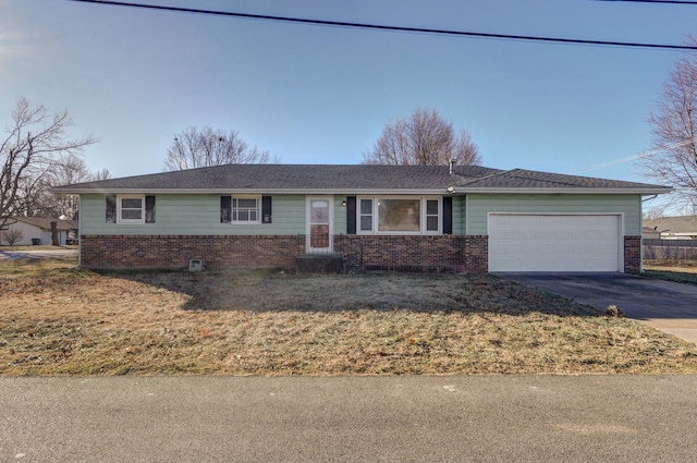 single story home with a front yard and a garage