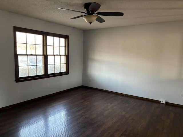 empty room with dark wood-type flooring, a textured ceiling, and ceiling fan