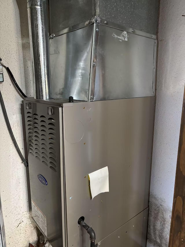 utility room featuring heating unit