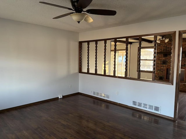 spare room featuring a textured ceiling, ceiling fan, and dark hardwood / wood-style flooring