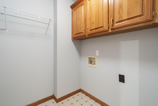 laundry area with cabinets, hookup for a washing machine, and hookup for an electric dryer